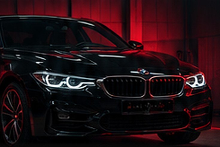 Premium black car with red lighting in the Amit Motors workshop